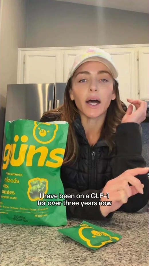 Gruns Facebook ad - creator on a GLP-1 holding a greens pouch